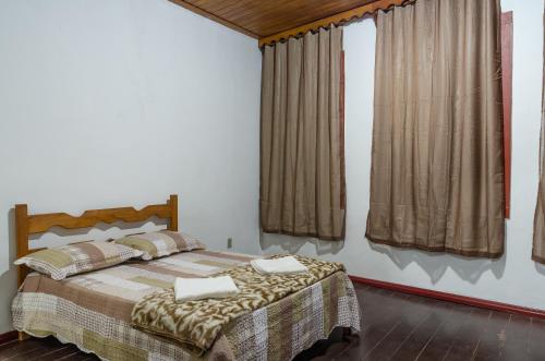 a bedroom with a bed with two pillows on it at Caminhos De Ouro Preto in Ouro Preto