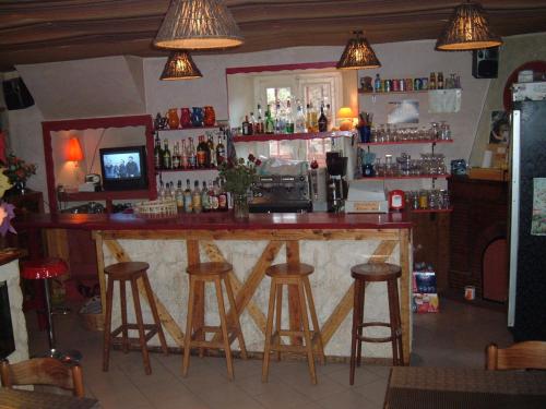 a bar in a restaurant with stools at Les 3 Marmottes in Lus-la-Croix-Haute