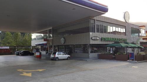 a car parked in a parking lot in front of a building at Win Win in Genting Highlands