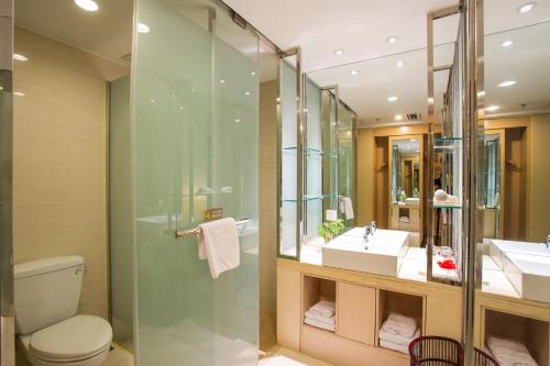 a bathroom with a shower and a toilet and a sink at Metropolo, Langfang, Wanda Plaza-Ningyuan Park in Langfang