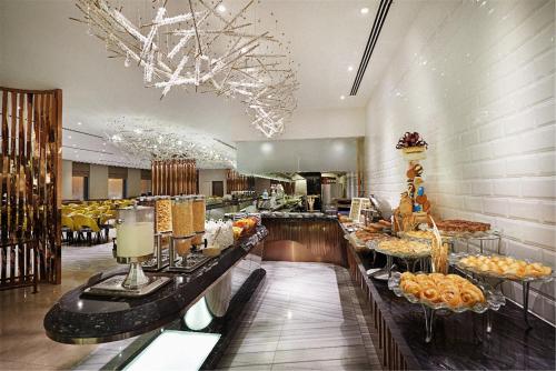 a buffet line in a restaurant with food on display at Dorsett Residences Bukit Bintang @Dorsett Kuala Lumpur in Kuala Lumpur