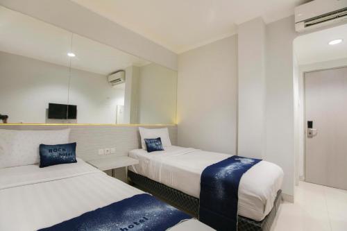 Postel nebo postele na pokoji v ubytování Rock Hotel