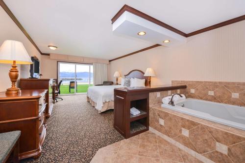a hotel room with a bed and a bath tub at Best Western Edgewater Resort in Sandpoint
