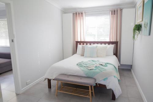 a small bedroom with a bed and a chair at Salty Shack Lancelin in Lancelin