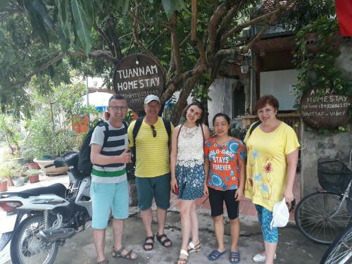 a group of people standing in front of a motorcycle at Tuan Nam Homestay in Ninh Binh