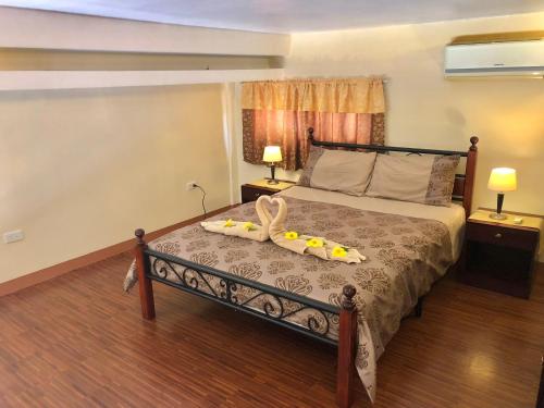 a bedroom with a bed with a tray on it at Pal-Watson Apartments in Mactan