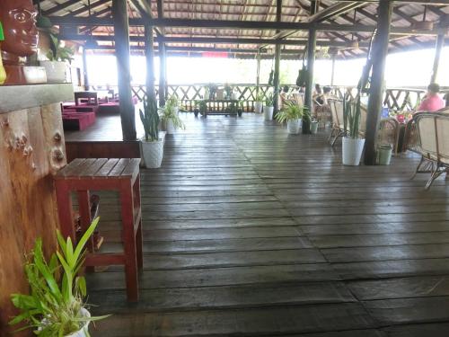a wooden floor with potted plants in a building at Greenhouse Retreat in Sen Monorom