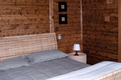 a bedroom with a bed with a wooden wall at I Giardini Di Margius in Itri