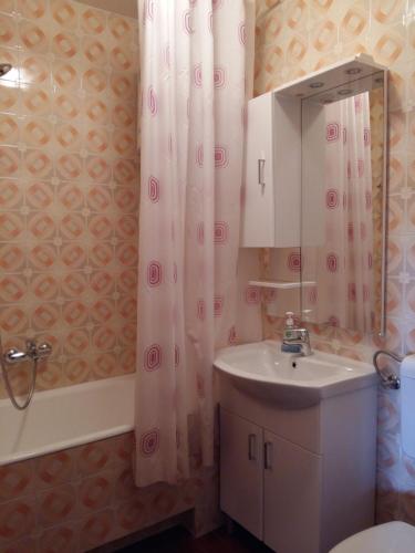 a bathroom with a sink and a shower curtain at AS Brela in Brela