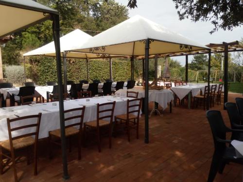 a group of tables and chairs under umbrellas at Società Agricola F.lli Angelucci in Cannara
