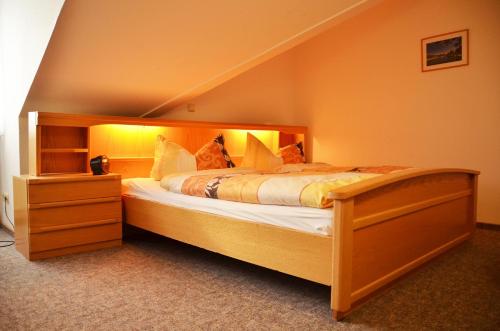 a bedroom with a large bed in a room at Landhaus Braband in Cuxhaven