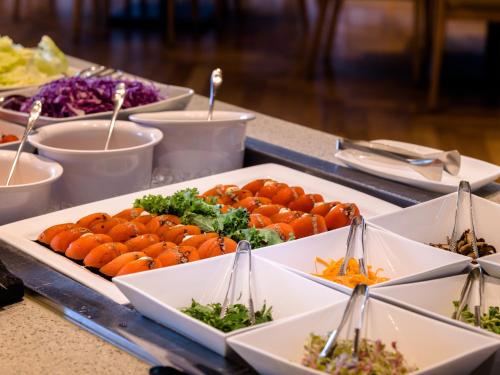 a buffet with plates of food on a table at Grabel Hotel Jeju in Jeju