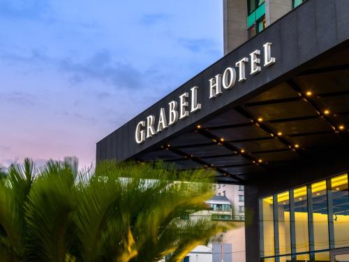 a building with a sign that reads grand hotel at Grabel Hotel Jeju in Jeju