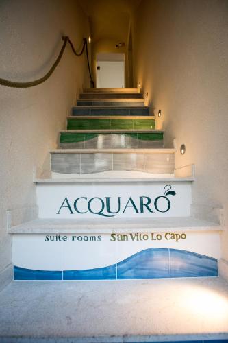 a set of stairs with a sign that reads acuraosa suite rooms san vit at Acquarò Suite in San Vito lo Capo