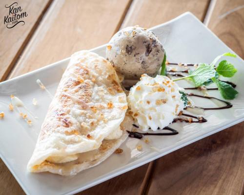 a plate of food with ice cream on a table at Shantaa Resort, Kohkood in Ko Kood