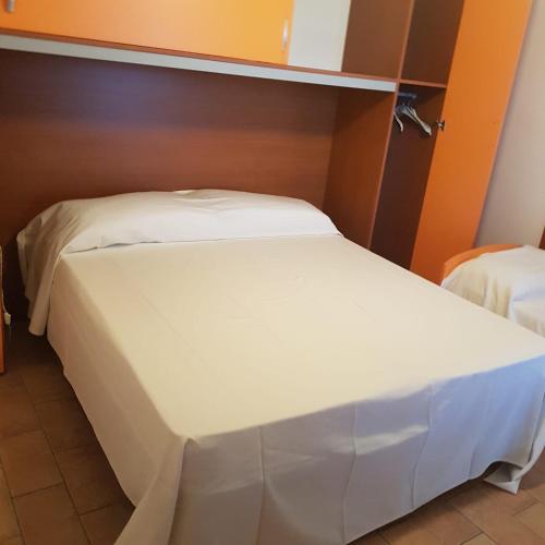 a large white bed in a room at allery in Alba Adriatica