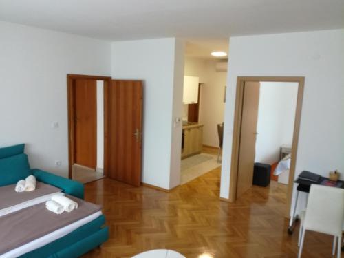 a bedroom with a bed and a dining room at Apartmani Oletić 4* in Sveti Martin na Muri