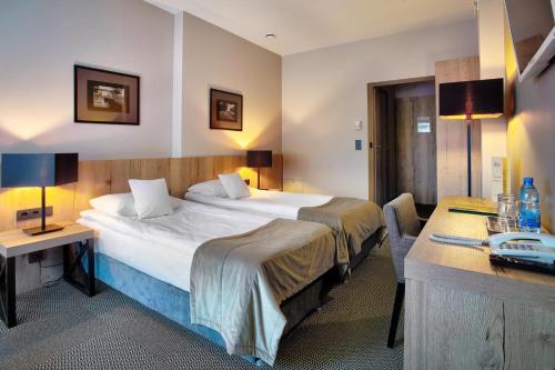 Una cama o camas en una habitación de Hotel Wojciech