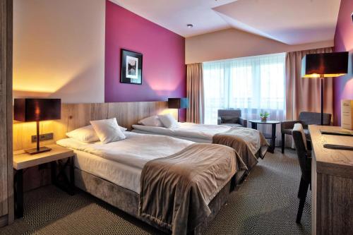 Una cama o camas en una habitación de Hotel Wojciech
