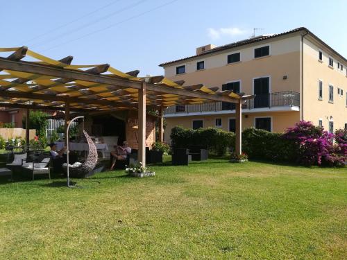 a pergola in a yard next to a building at Victoria Resort in Ascea