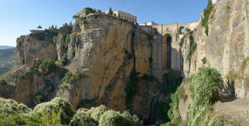 a building on the side of a mountain at Hotel & Spa PLAZA Arriate in Arriate