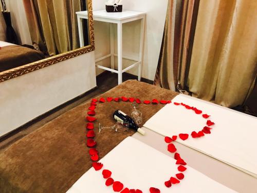 a clock with red beads on a table in front of a mirror at Central Business Apartments Jacuzzi in Belgrade