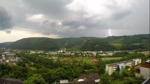 a lightning bolt in the sky over a city at Ferienwohnung Sonnenfels **** in Bad Ems