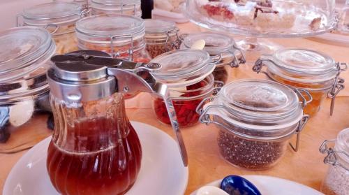 a table topped with jars of jam on a table at Victoria Resort in Ascea