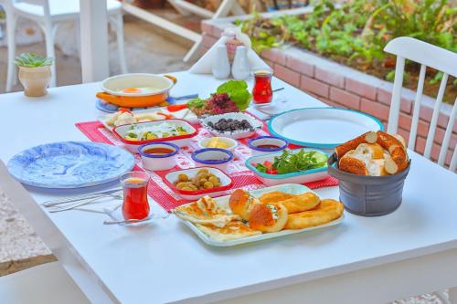 a table with plates of food on top of it at Dantel Butik Ev Pansiyon in Kas