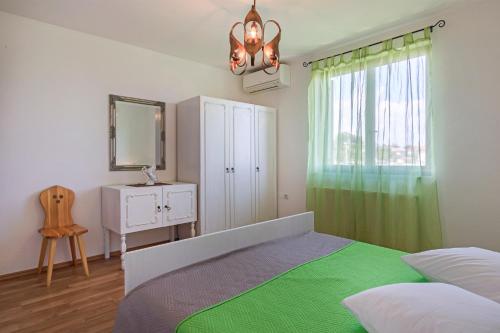 a bedroom with a bed and a mirror and a window at vila lokvanj in Ližnjan