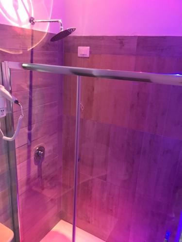 a shower with a glass door in a bathroom at Acquarium Tropea in Tropea