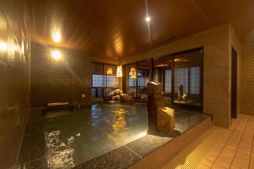 a room with a pool of water in a building at Dormy Inn Premium Namba ANNEX Natural Hot Spring in Osaka