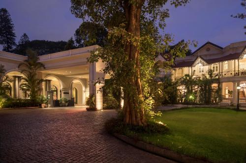 a large building with a tree in front of it at Taj West End in Bangalore