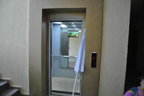 a bathroom with a mirror and an umbrella at the View Apartment in Makhinjauri
