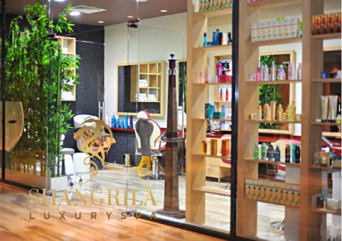 a hair salon with a mirror in a store at Euphoria Apartments in Batumi