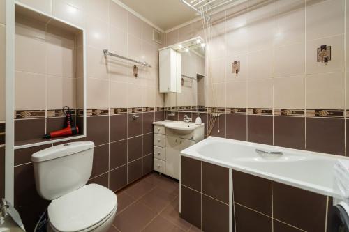 a bathroom with a toilet and a sink at Apart-Comfort Kyoto in Yaroslavl