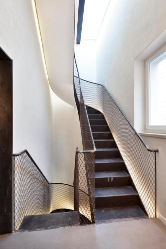a staircase in a building with a window at Palazzo Calò in Bari