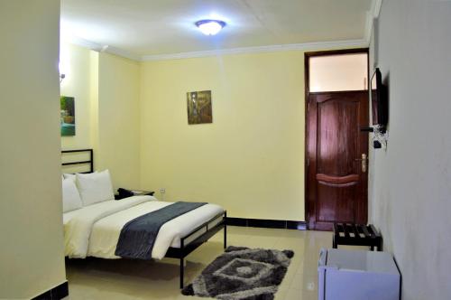 Postel nebo postele na pokoji v ubytování M Hotel