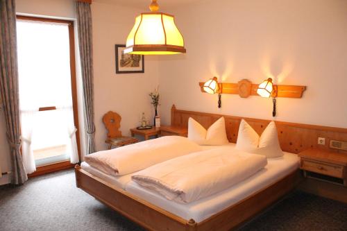 a bedroom with a large bed with a large window at Sindersdorfer Hof in Hilpoltstein
