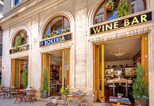 a wine bar with tables and chairs in front of a building at Abokamento Boutique Rooms in Split