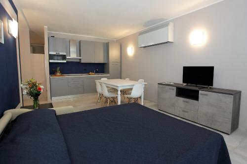 a bedroom with a bed and a kitchen with a table at Il Convento Case Vacanze in Rapallo