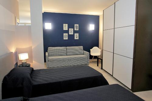 a bedroom with a bed and a couch at Il Convento Case Vacanze in Rapallo