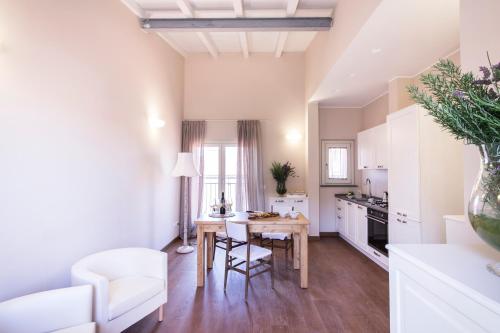 a small kitchen with a table and a white couch at Agave in Città in Livorno