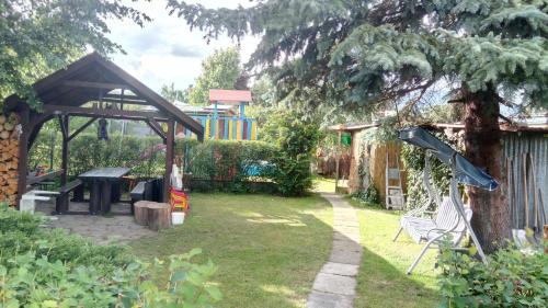 a garden with a picnic table and a playground at Svit Dovolenkový dom in Svit