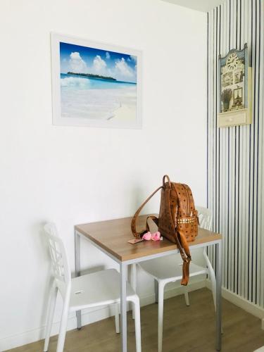 a table and chair with a purse on it at บ้านเพียงเพลิน in Hua Hin