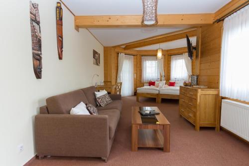a living room with a couch and a table at Hotel & Restaurant Wilder Eber in Eberswalde-Finow