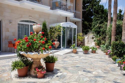 a bunch of potted plants in front of a building at Porto Plakias & Spa in Plakias