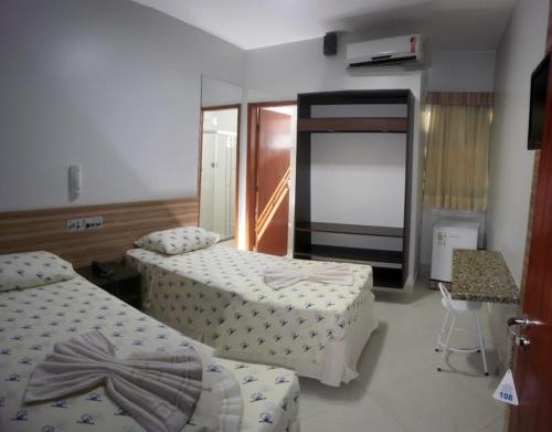 Ένα ή περισσότερα κρεβάτια σε δωμάτιο στο Rede Andrade Porto Mar