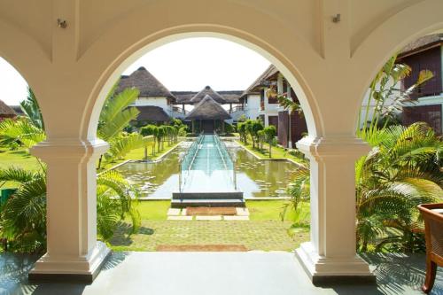 an archway leading to a pool in a villa at Le Pondy in Puducherry