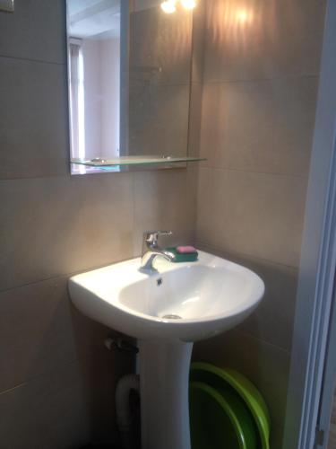 a bathroom with a white sink and a mirror at Nodari in Batumi